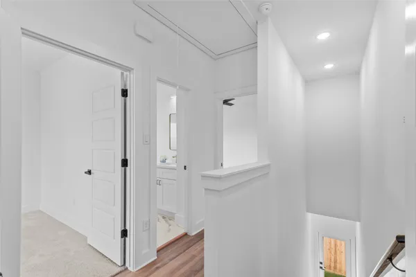 a view of a hallway with wooden floor