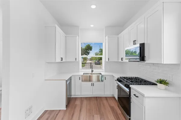 a kitchen that has a sink and a stove in it