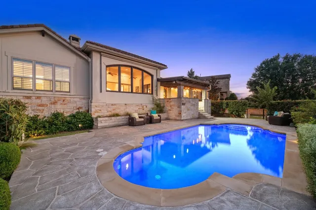 a view of a house with swimming pool and yard