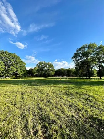 a view of a swimming pool with a yard