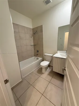 a bathroom with a sink a toilet and a bathtub