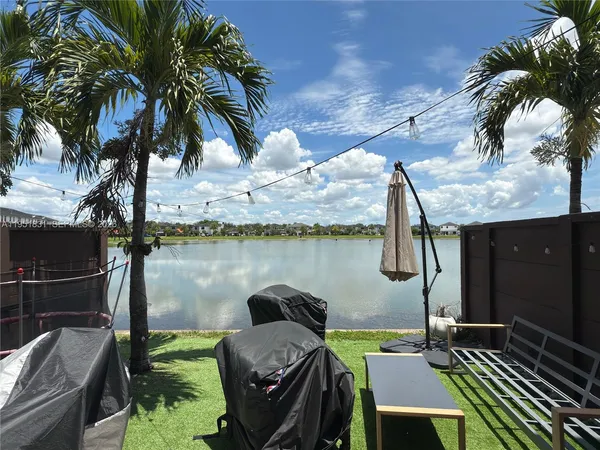 a view of a balcony with lake view and a potted plant