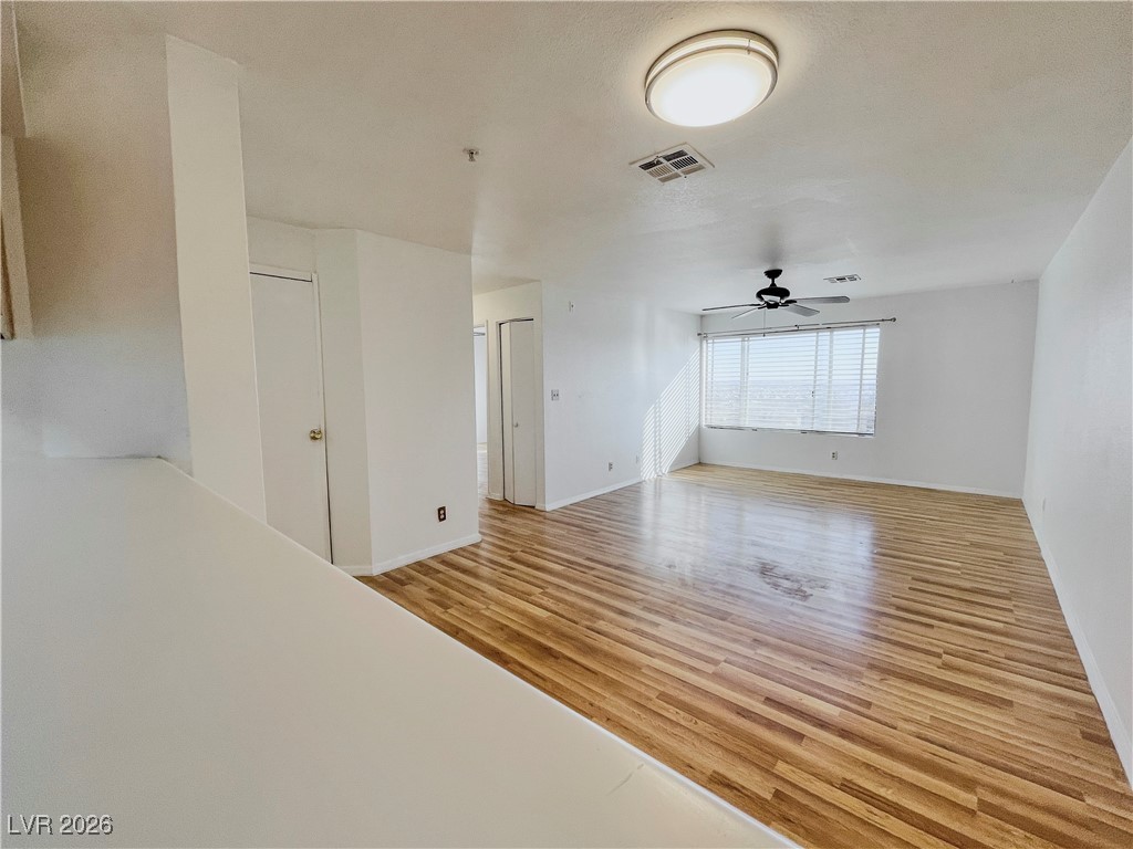 2044 Mesquite Lane, Unit 202 Laughlin, NV 89029 - Photo 12 of 47 Dining Area and Family Room featuring light wood finished floors, baseboards, a ceiling fan, and visible vents