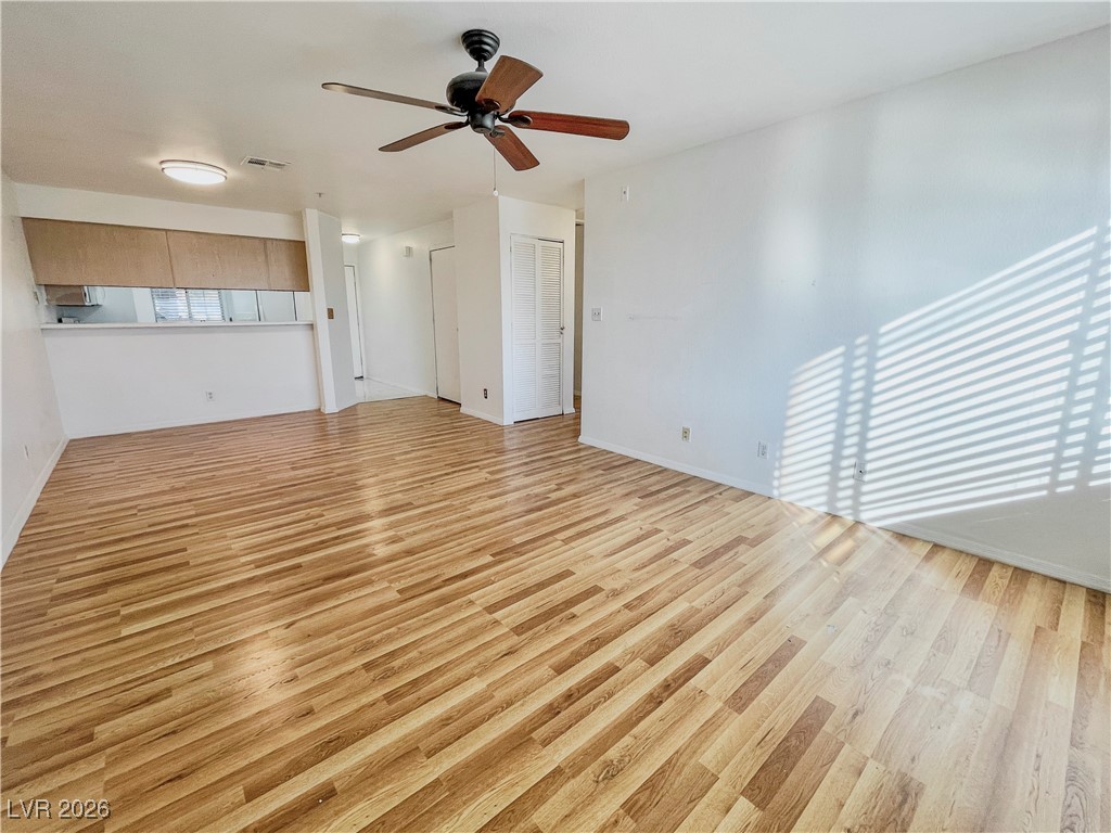 2044 Mesquite Lane, Unit 202 Laughlin, NV 89029 - Photo 14 of 47 Family room with ceiling fan, baseboards, and light wood-style flooring