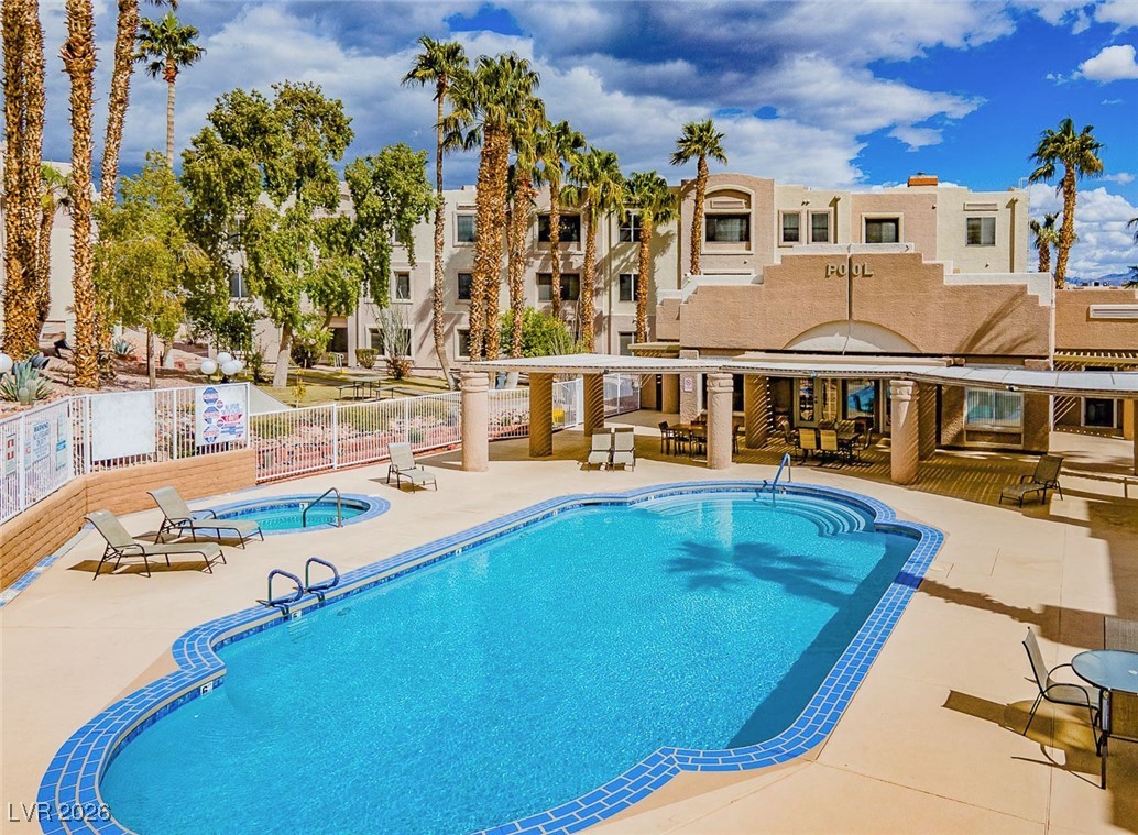 2044 Mesquite Lane, Unit 202 Laughlin, NV 89029 - Photo 38 of 47 Community Pool with fence, a patio area, a community hot tub, and a residential view