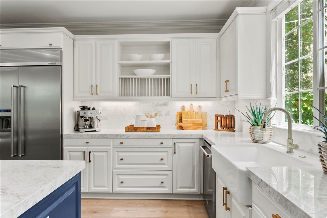 15 Winfield Drive Ladera Ranch, CA 92694 - Photo 10 of 43 a kitchen with granite countertop a sink a window and cabinets