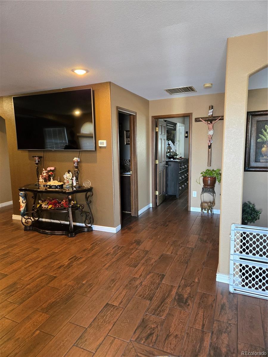 633 South Stuart Street Denver, CO 80219 - Photo 11 of 28 a living room with furniture and a flat screen tv