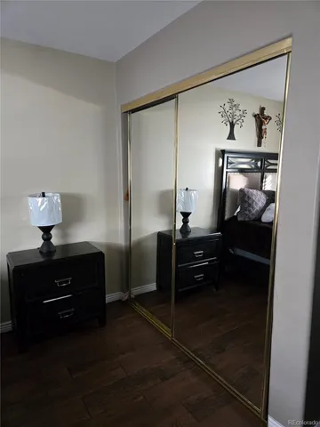 a bedroom with a bed and a lamp on table