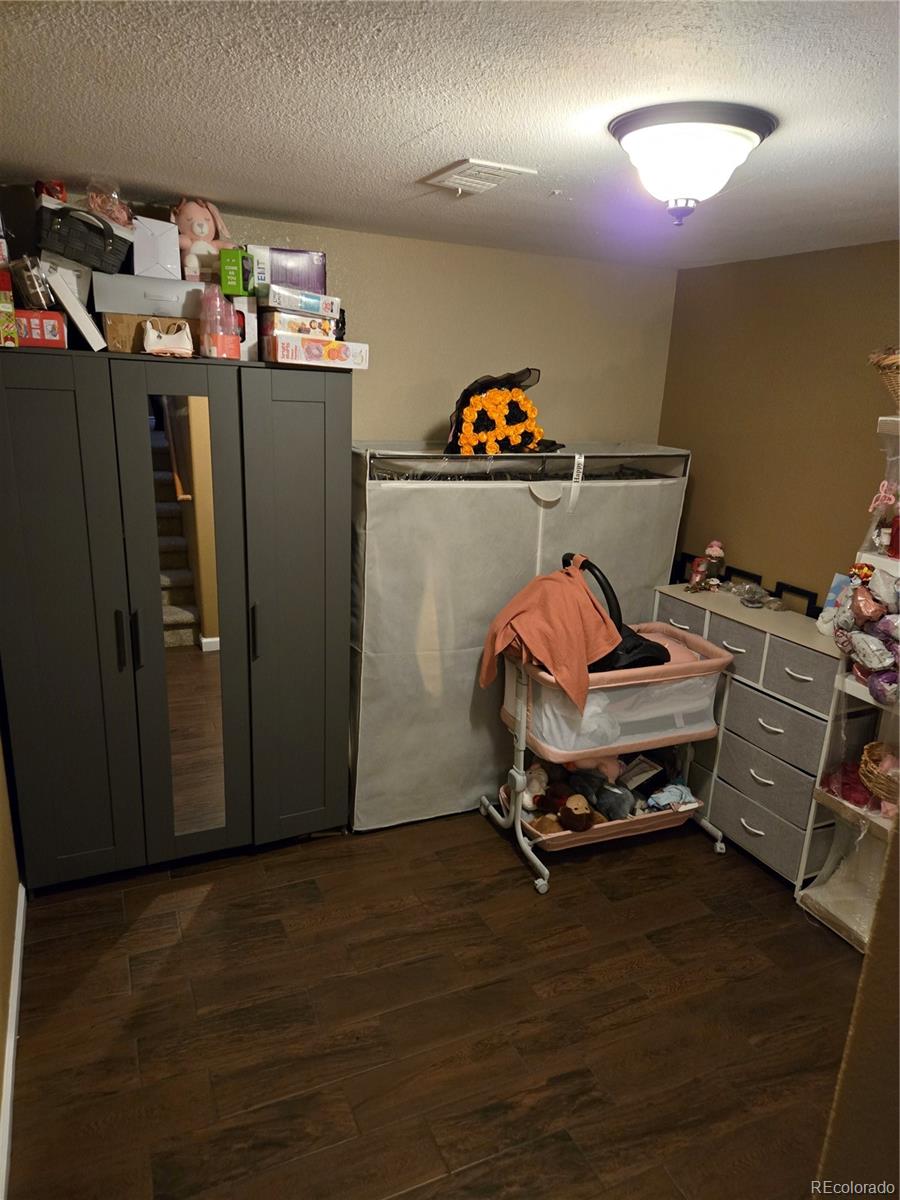 633 South Stuart Street Denver, CO 80219 - Photo 20 of 28 a storage room with wooden floor and shoes