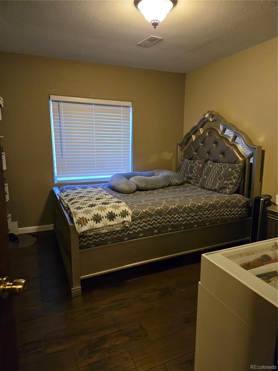 633 South Stuart Street Denver, CO 80219 - Photo 21 of 28 a bed sitting in a bedroom next to a yard