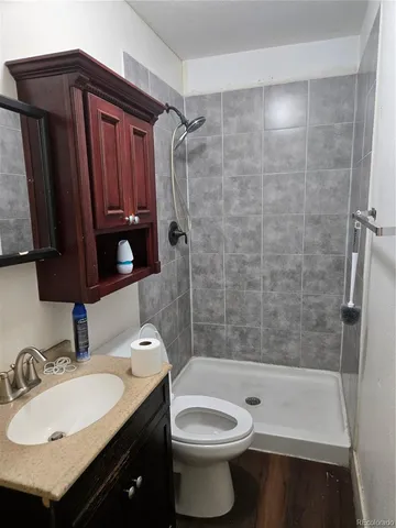 a bathroom with a sink toilet and shower