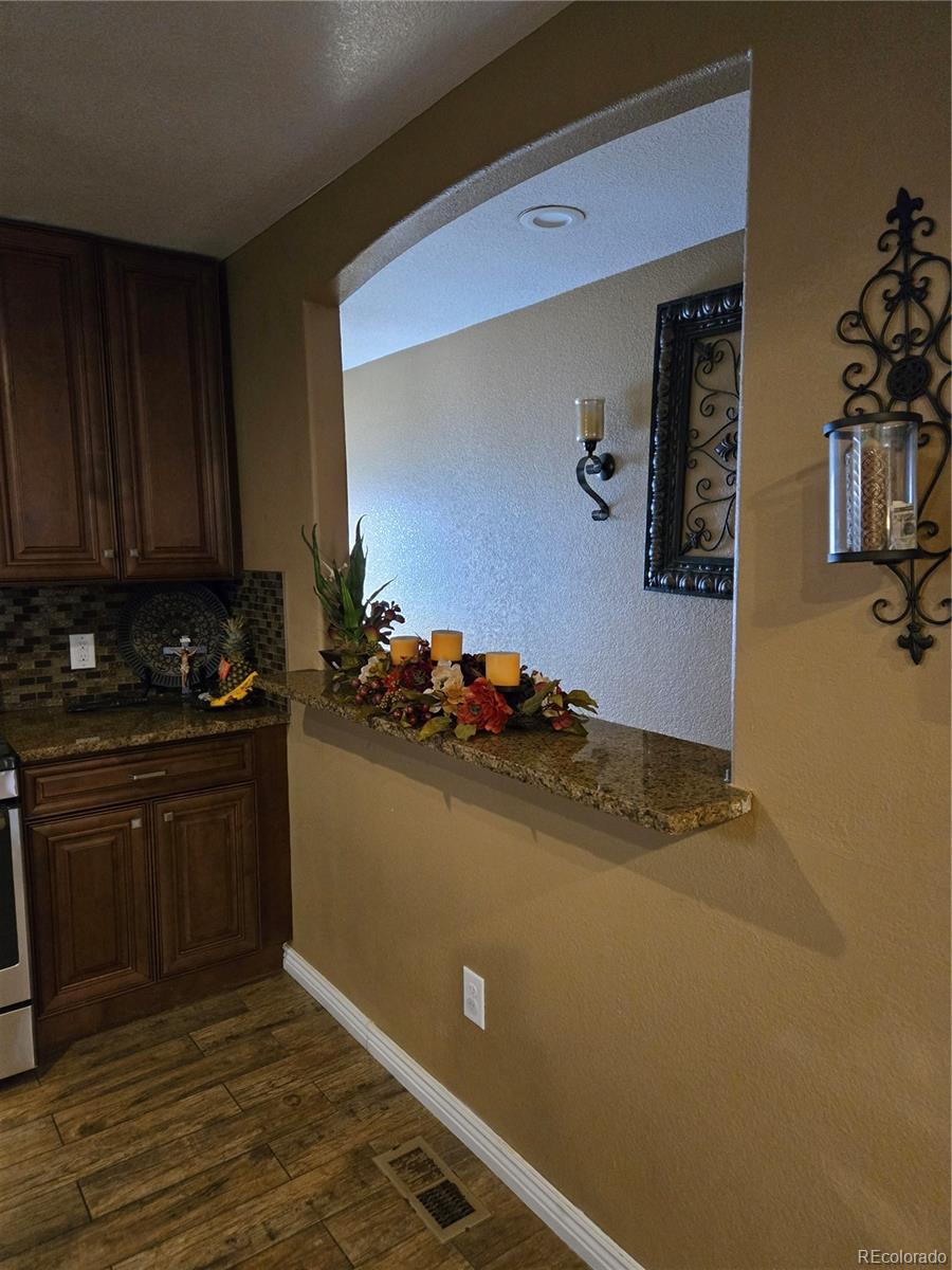 633 South Stuart Street Denver, CO 80219 - Photo 5 of 28 a kitchen with a sink and cabinets