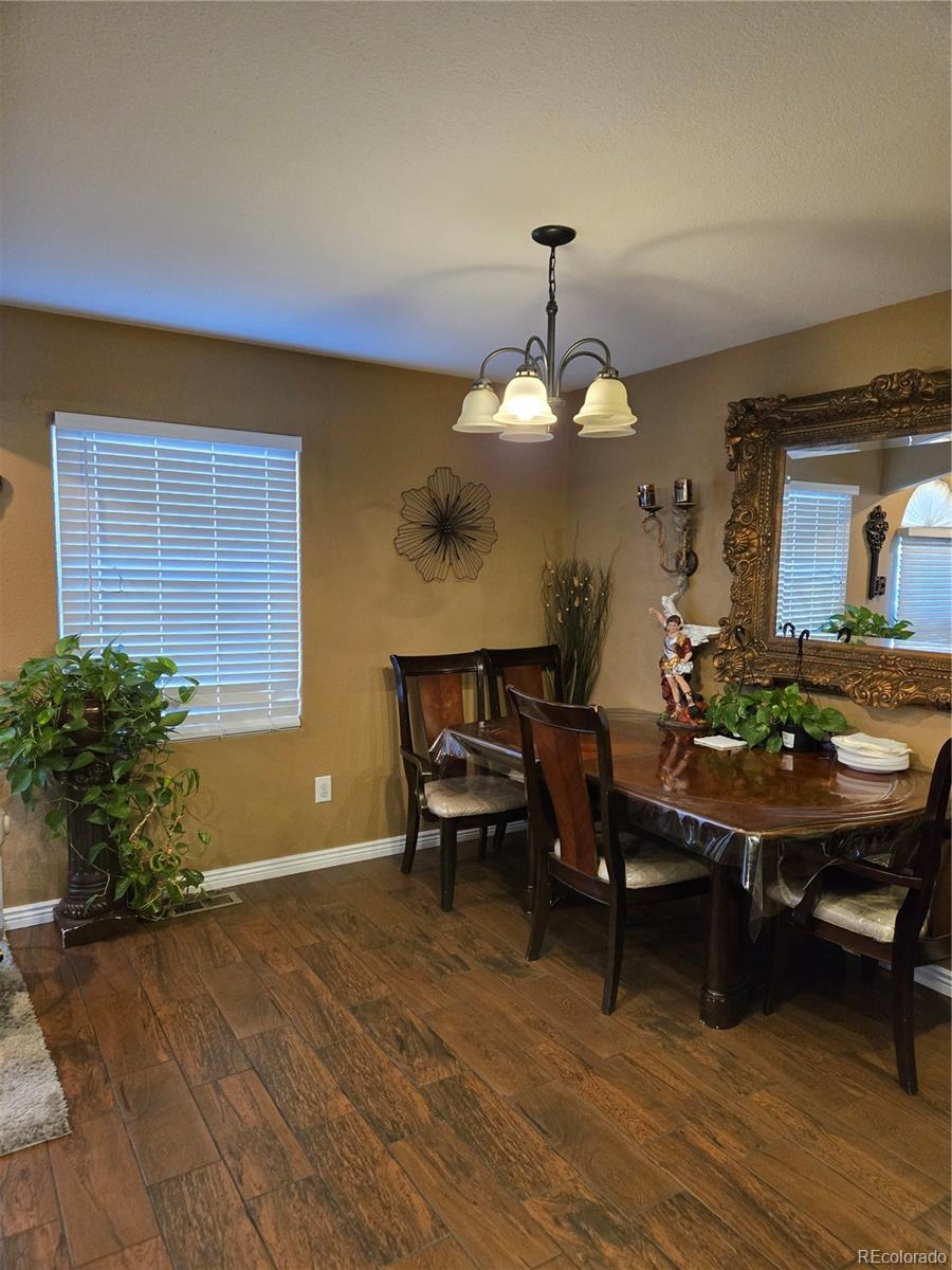 633 South Stuart Street Denver, CO 80219 - Photo 7 of 28 a view of a dining room with furniture and wooden floor