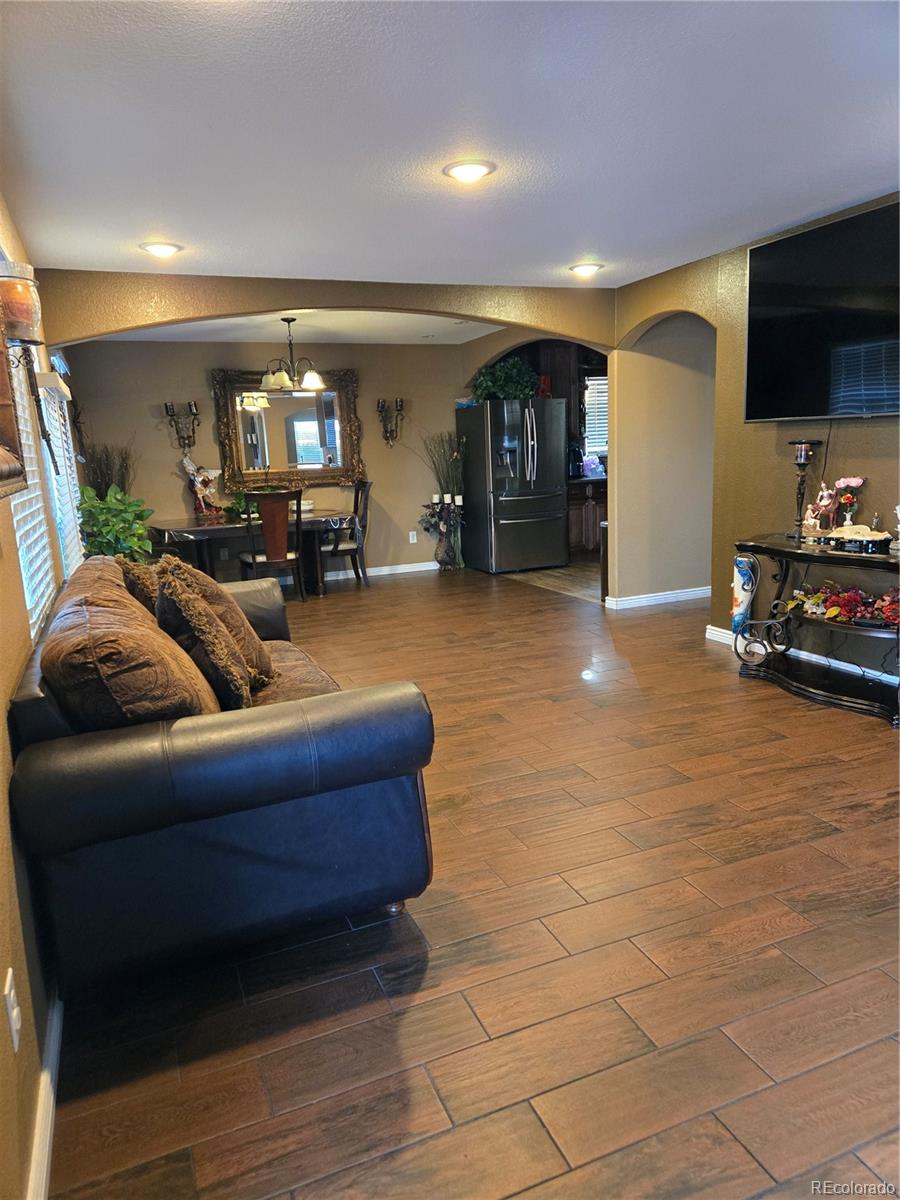 633 South Stuart Street Denver, CO 80219 - Photo 8 of 28 a living room with furniture and a flat screen tv