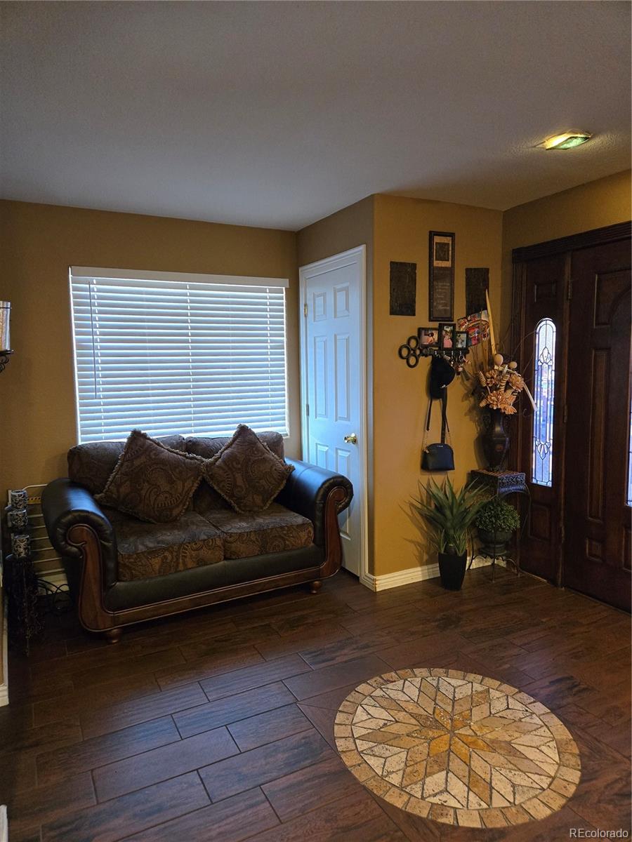 633 South Stuart Street Denver, CO 80219 - Photo 9 of 28 a living room with furniture a dining table and a window