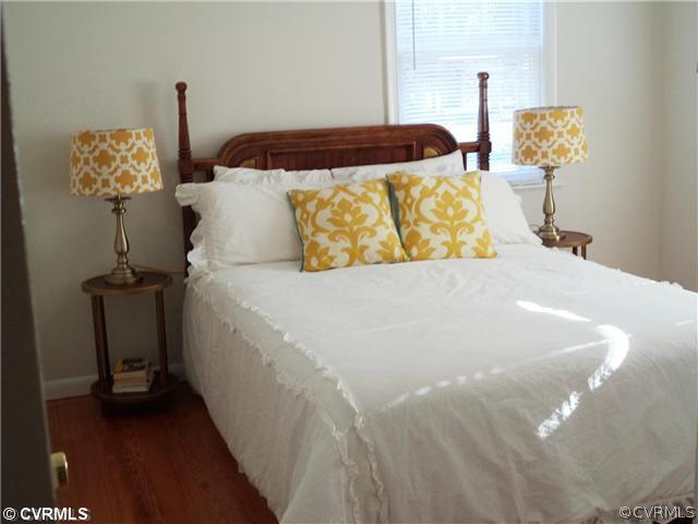 8156 Varina Road Henrico, VA 23231 - Photo 7 of 16 a bed sitting in a bedroom next to a lamp
