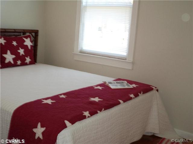 8156 Varina Road Henrico, VA 23231 - Photo 8 of 16 a bed sitting in a bedroom next to a window