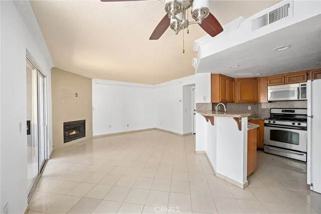 a view of a kitchen with a sink oven cabinets and window