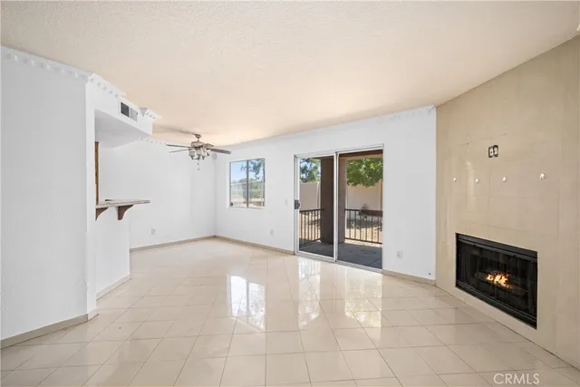 a view of a livingroom with a fireplace and window