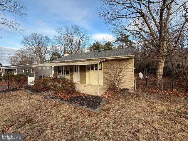 a house that has a tree in front of it