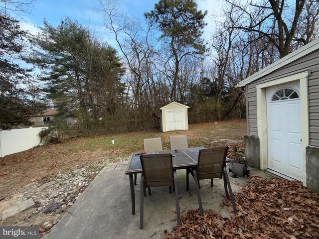 a view of a patio with table and chairs and couches