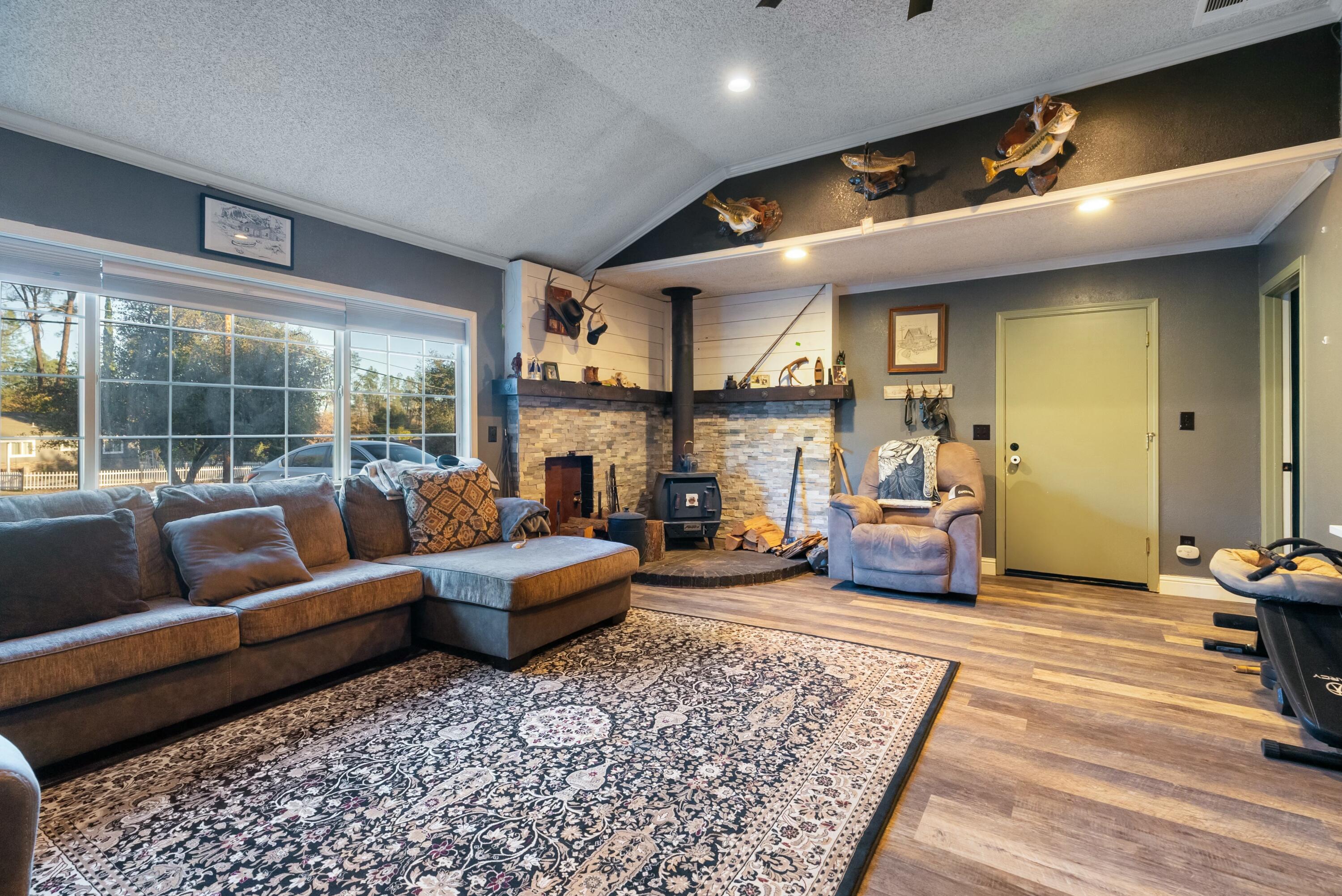 3145 Quartz Hill Road Redding, CA 96003 - Photo 11 of 32 a living room with furniture and a fireplace