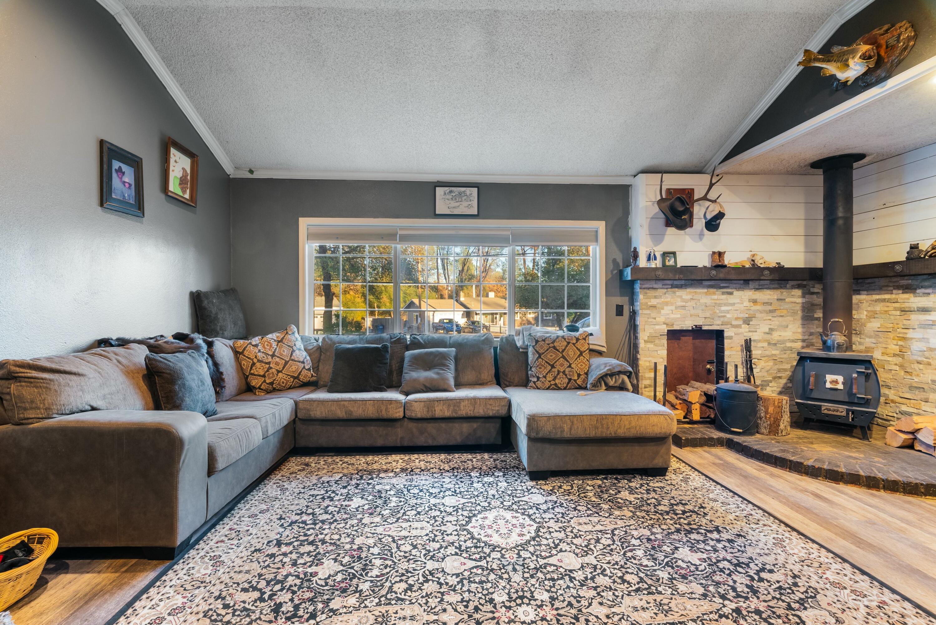 3145 Quartz Hill Road Redding, CA 96003 - Photo 12 of 32 a living room with furniture and a fireplace
