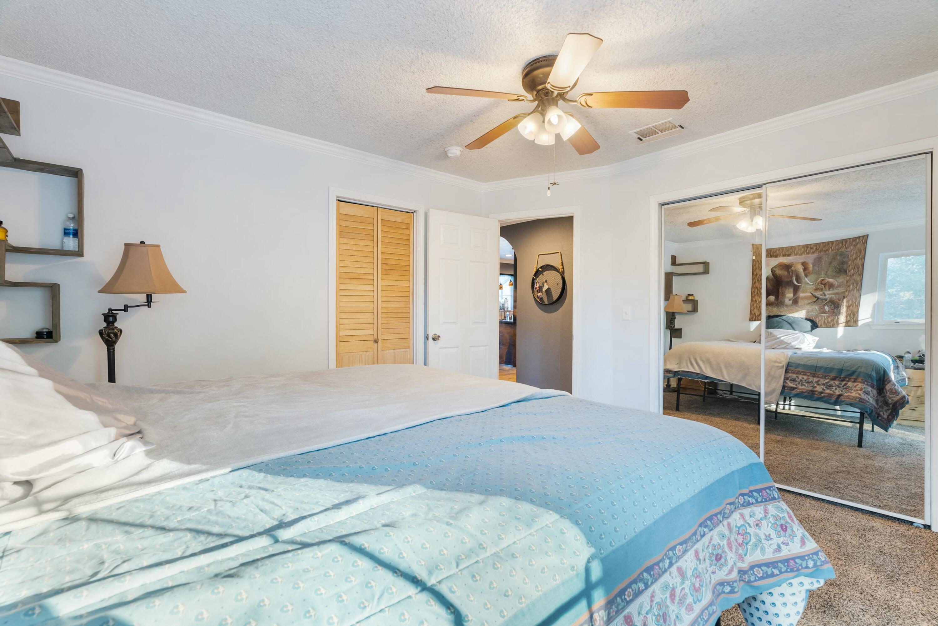 3145 Quartz Hill Road Redding, CA 96003 - Photo 16 of 32 a bedroom with a bed and a chandelier