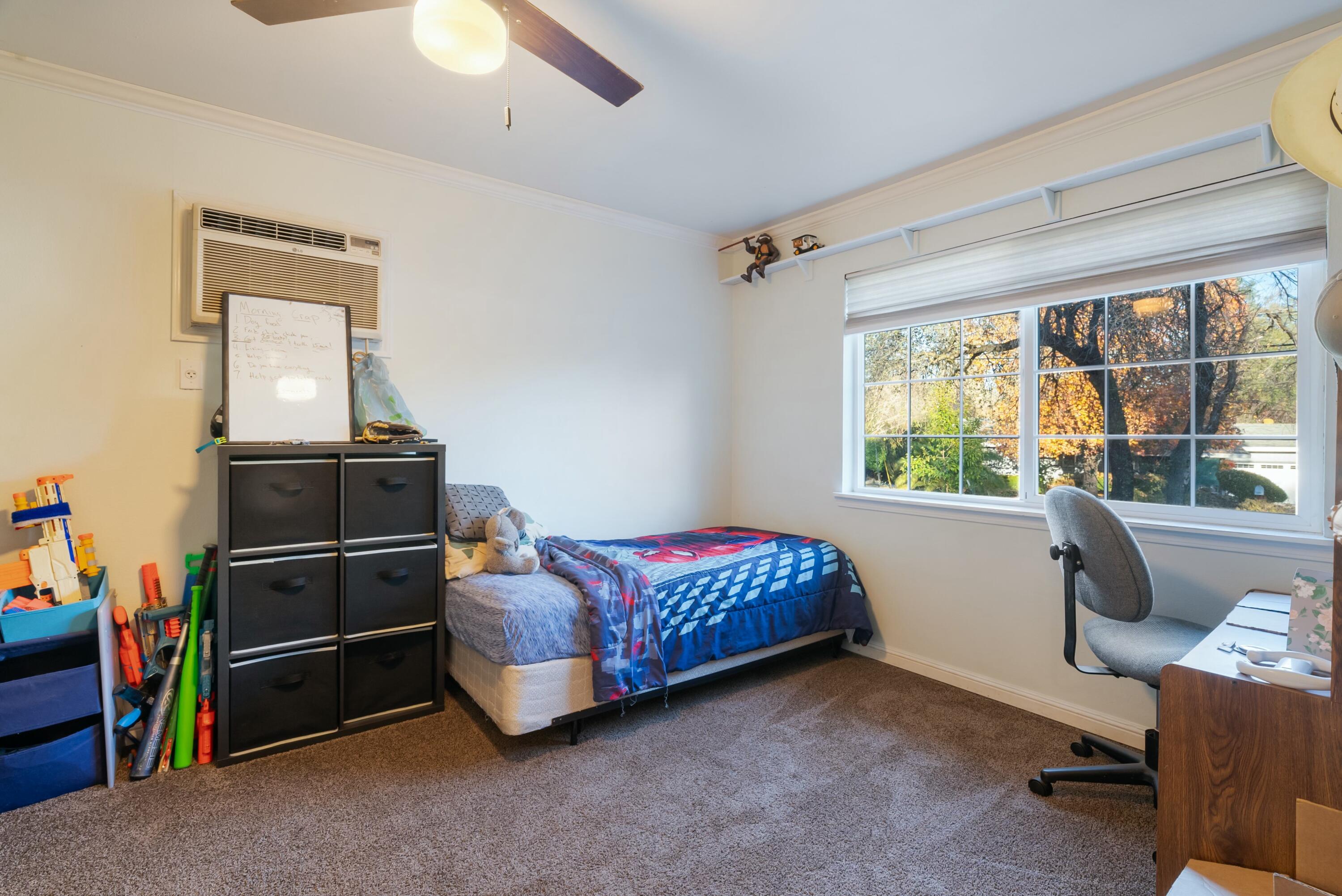 3145 Quartz Hill Road Redding, CA 96003 - Photo 19 of 32 a bedroom with a bed and a window