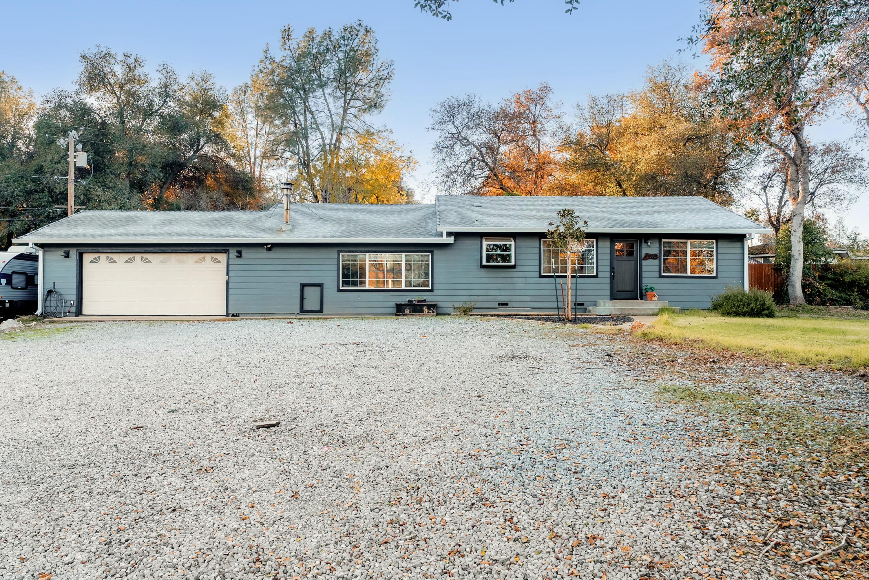 3145 Quartz Hill Road Redding, CA 96003 - Photo 2 of 32 a front view of a house with a yard and trees
