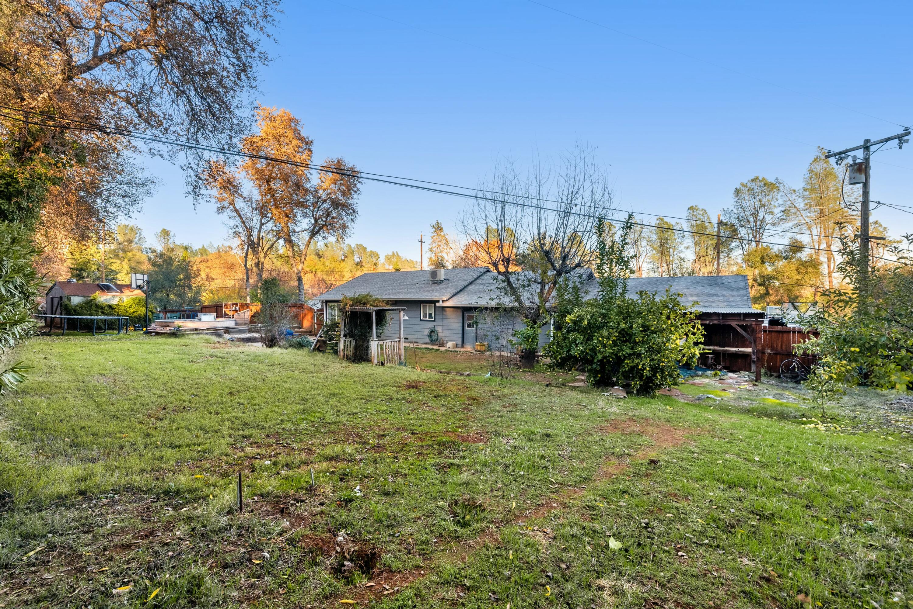 3145 Quartz Hill Road Redding, CA 96003 - Photo 27 of 32 a view of a house with a back yard