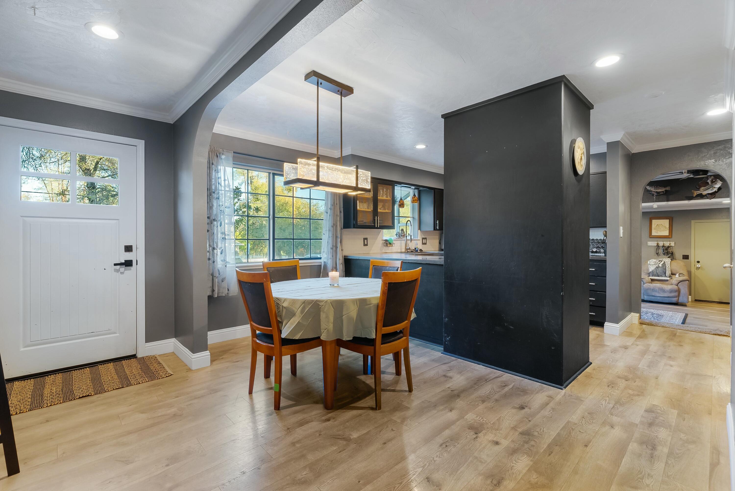 3145 Quartz Hill Road Redding, CA 96003 - Photo 6 of 32 a dining room with furniture a chandelier and wooden floor