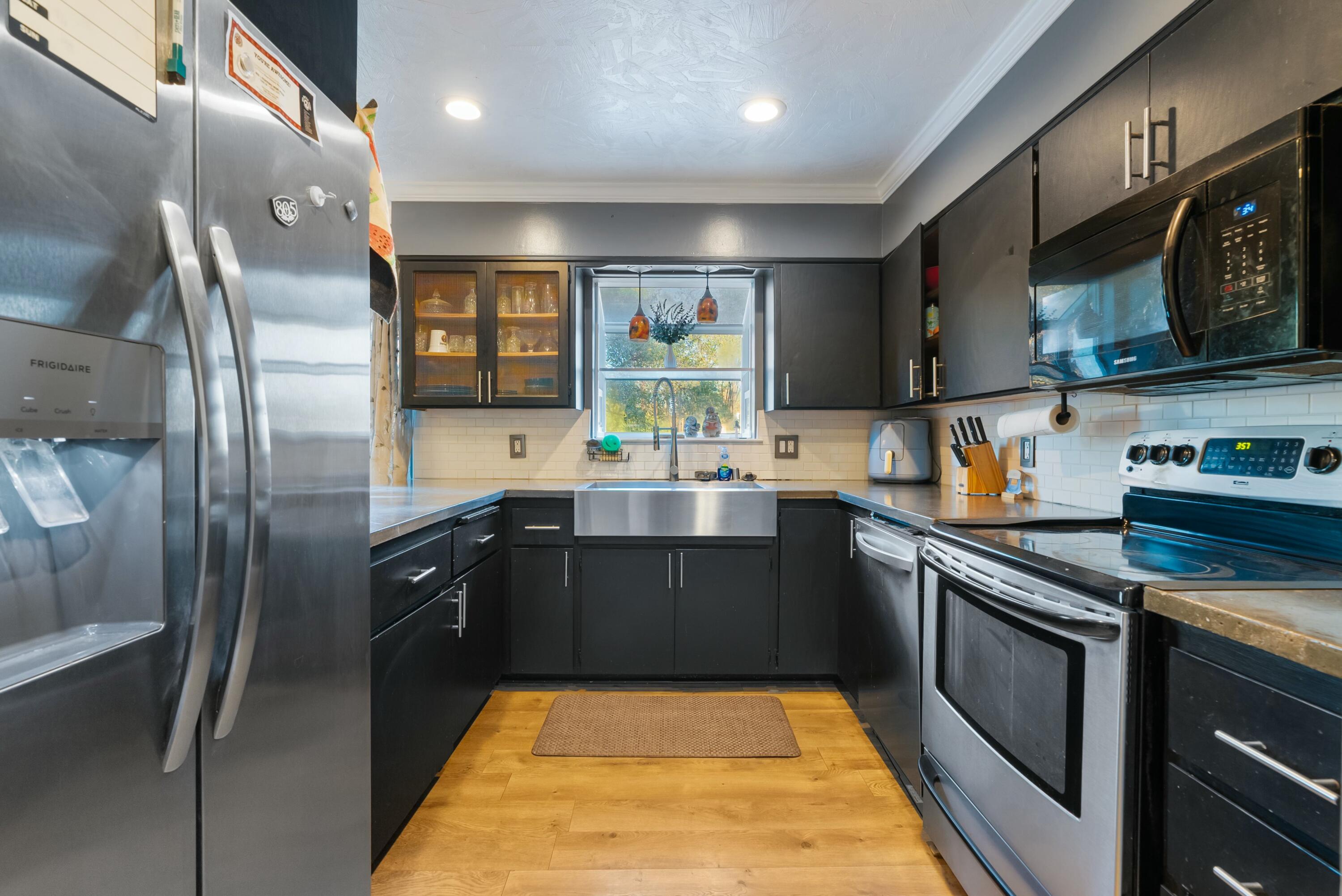 3145 Quartz Hill Road Redding, CA 96003 - Photo 7 of 32 a kitchen with stainless steel appliances granite countertop a sink stove and refrigerator