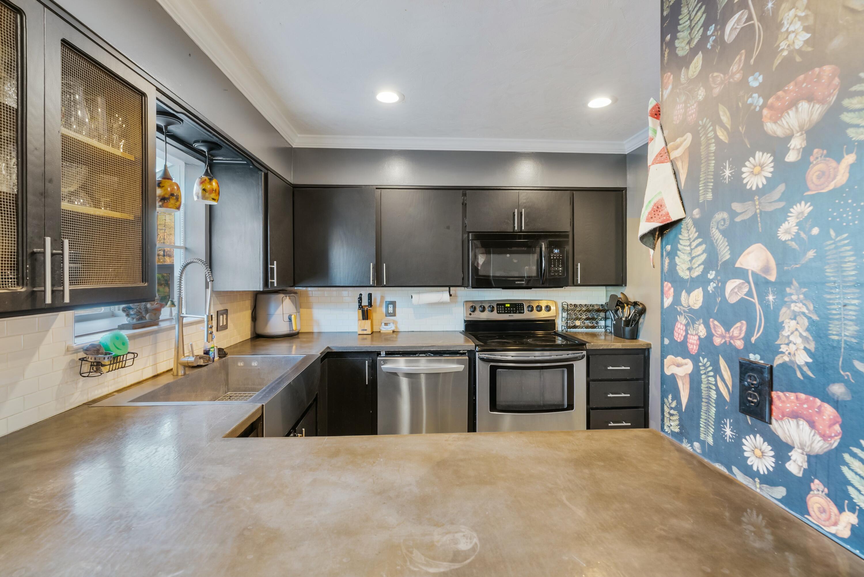 3145 Quartz Hill Road Redding, CA 96003 - Photo 8 of 32 a large kitchen with stainless steel appliances and a sink