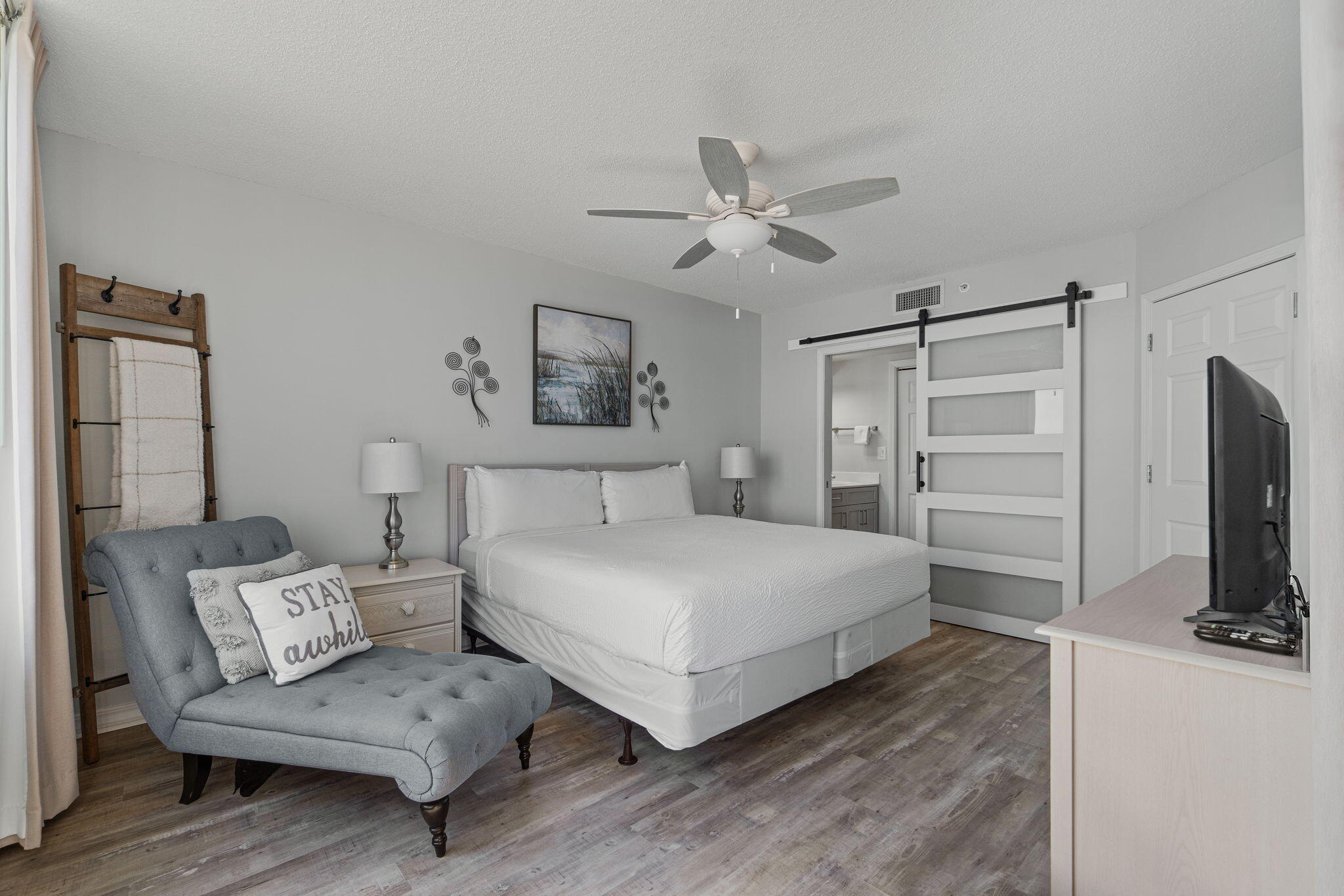 520 Santa Rosa Boulevard, Unit 404 Fort Walton Beach, FL 32548 - Photo 14 of 44 a bedroom with a bed a couch and a chandelier