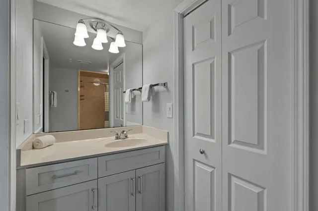 a bathroom with a double vanity sink and a mirror