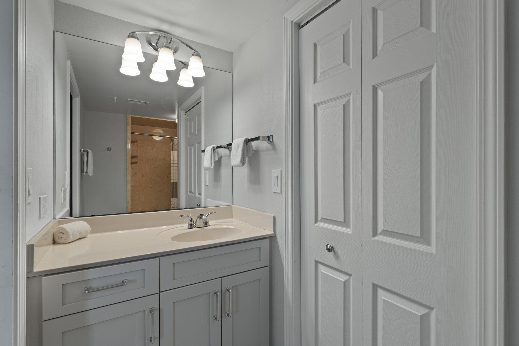 520 Santa Rosa Boulevard, Unit 404 Fort Walton Beach, FL 32548 - Photo 15 of 44 a bathroom with a double vanity sink and a mirror