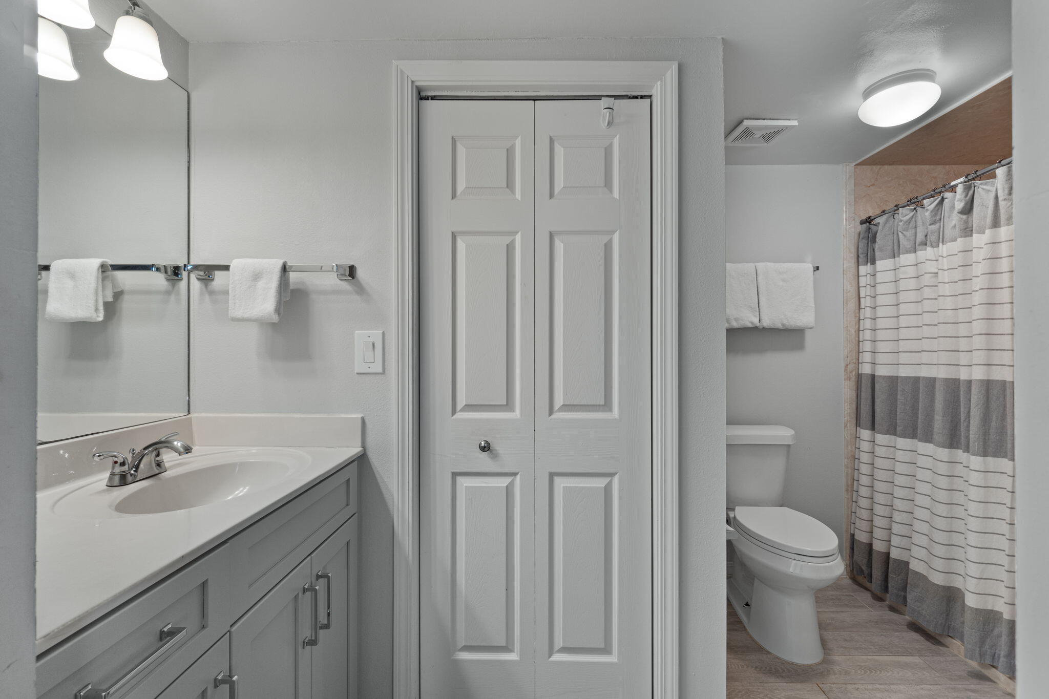 520 Santa Rosa Boulevard, Unit 404 Fort Walton Beach, FL 32548 - Photo 16 of 44 a bathroom with a granite countertop sink a toilet and a shower