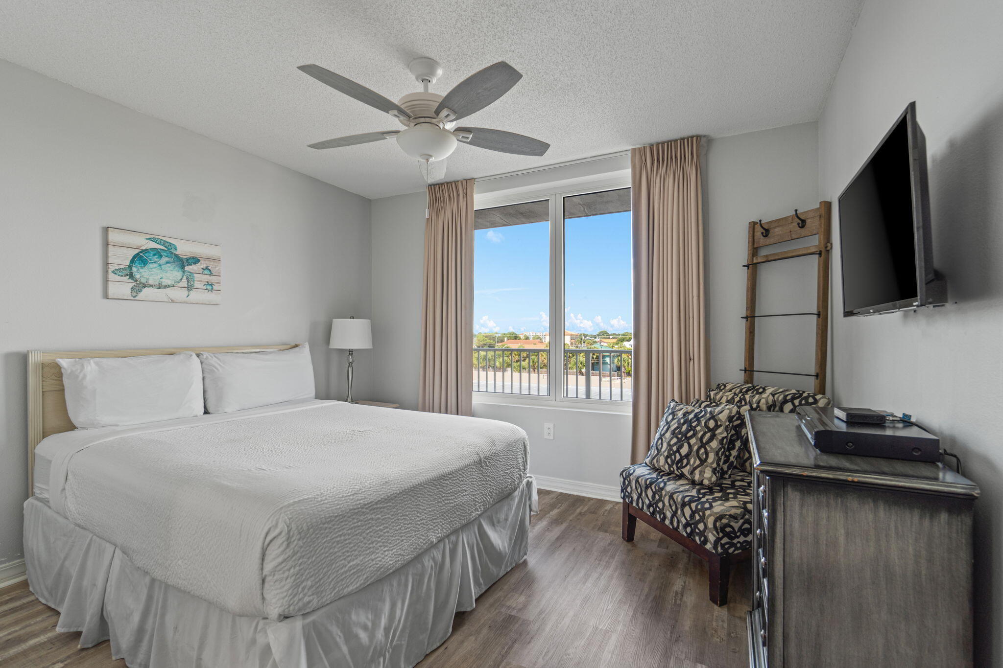 520 Santa Rosa Boulevard, Unit 404 Fort Walton Beach, FL 32548 - Photo 18 of 44 a bedroom with a bed and a flat screen tv