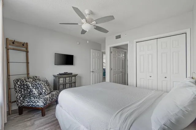 a spacious bedroom with a bed and a television