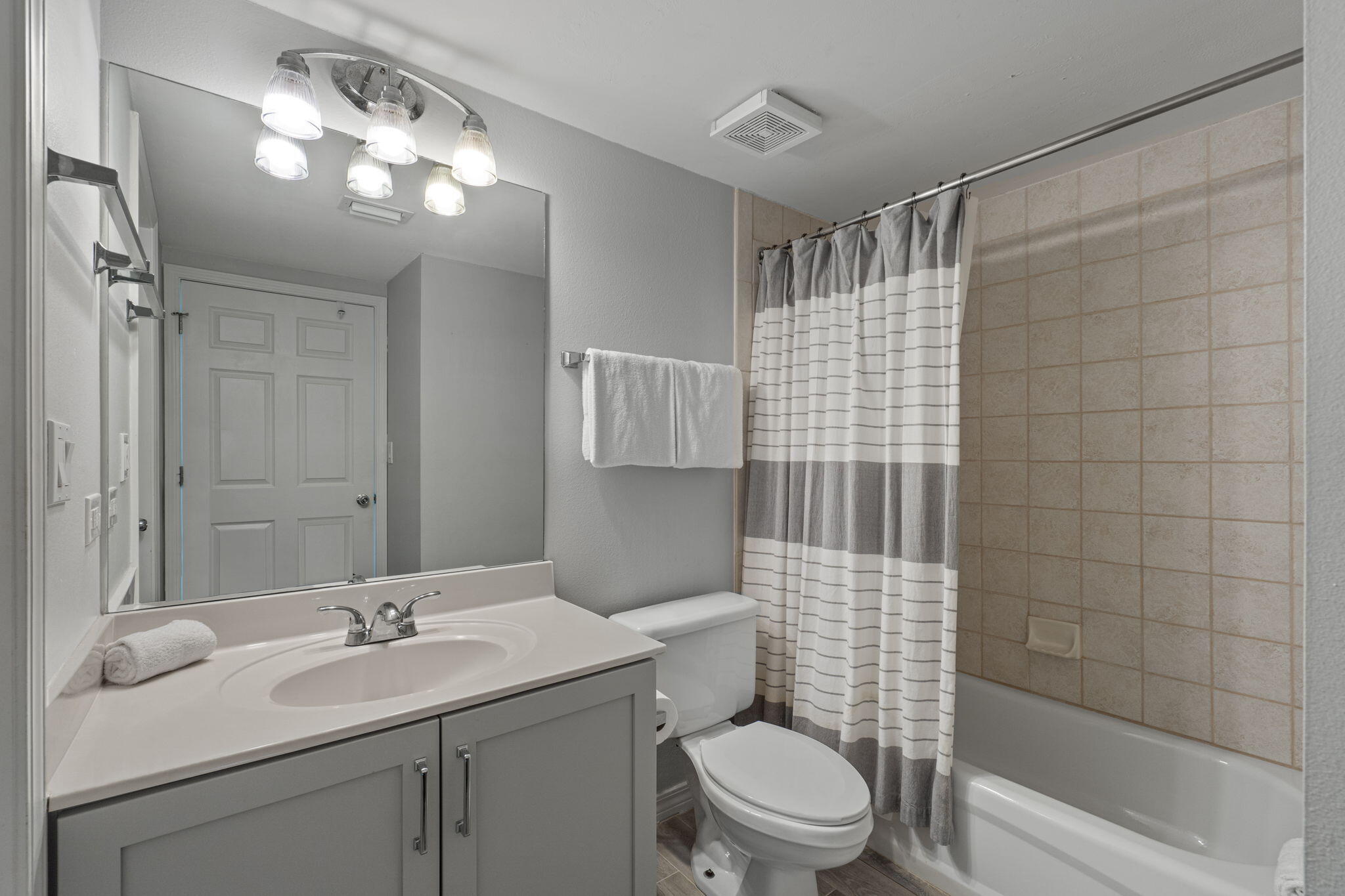 520 Santa Rosa Boulevard, Unit 404 Fort Walton Beach, FL 32548 - Photo 20 of 44 a bathroom with a sink toilet vanity and shower