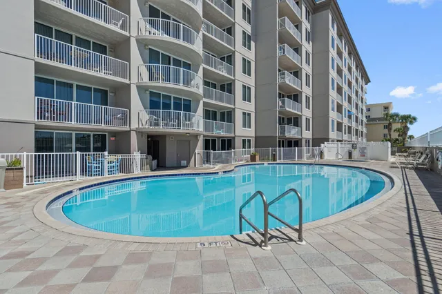 a view of a swimming pool with a lounge chair