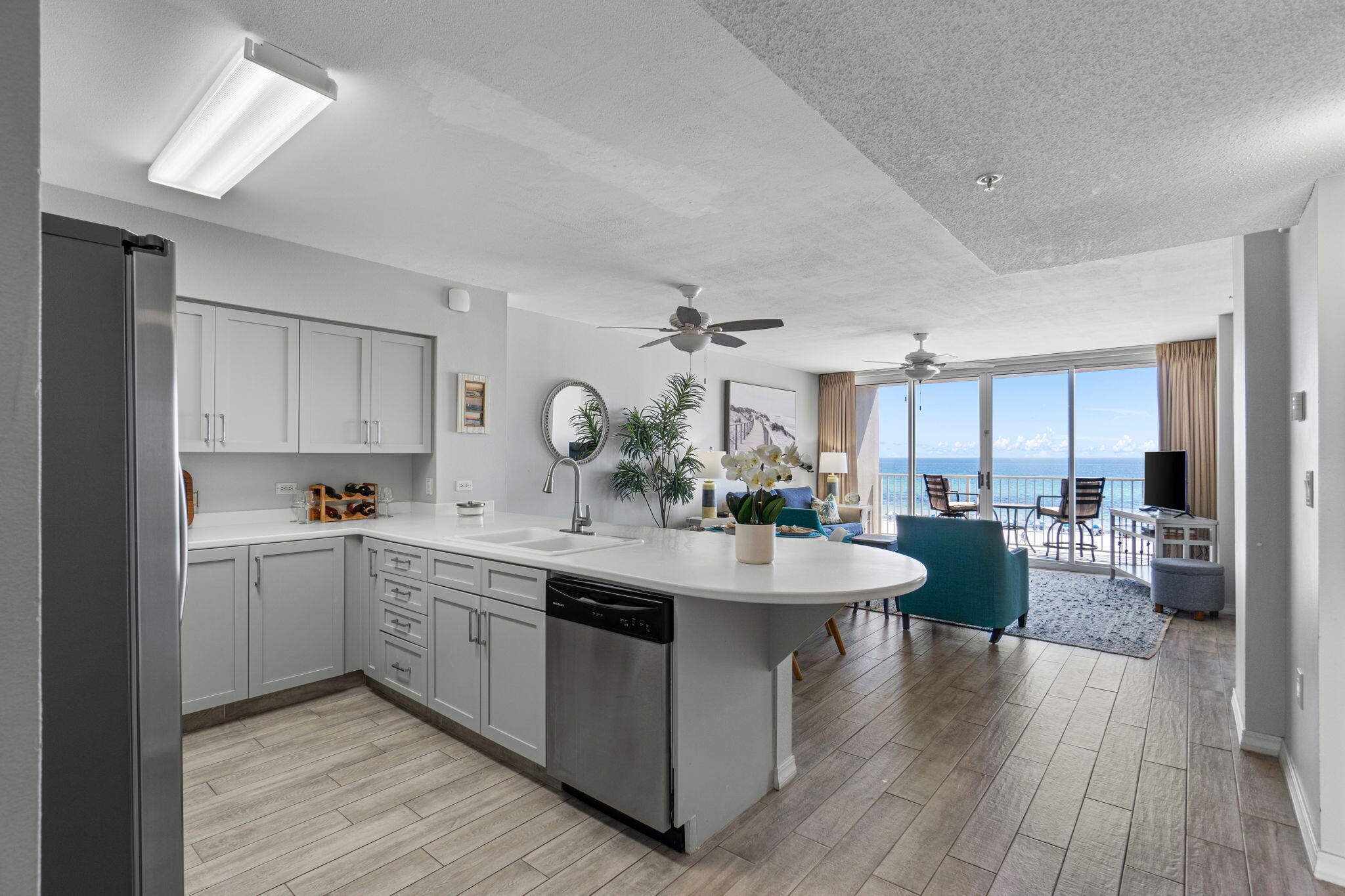 520 Santa Rosa Boulevard, Unit 404 Fort Walton Beach, FL 32548 - Photo 6 of 44 a view of a kitchen counter top space with sink wooden floor and view living room