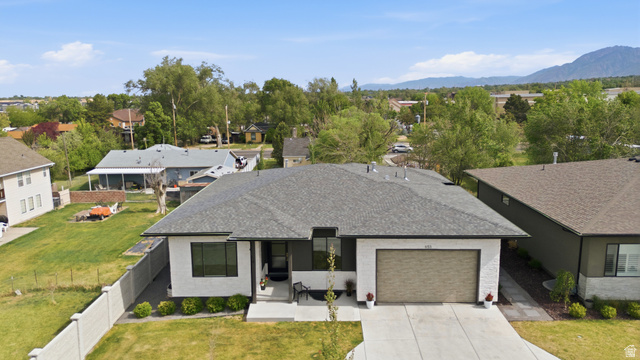 653 East Vandalay Lane Draper, UT 84020 - Photo 50 of 61 Contemporary single-story residence with a gray shingle roof and a two-car garage
