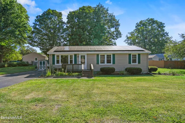a front view of a house with a garden