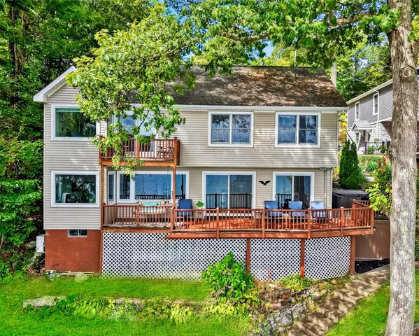 a front view of a house with garden and sitting area