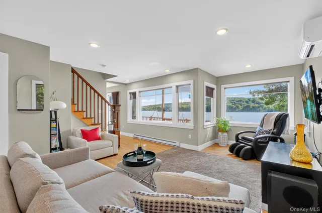 a living room with furniture and a floor to ceiling window
