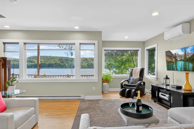 a living room with furniture and a floor to ceiling window
