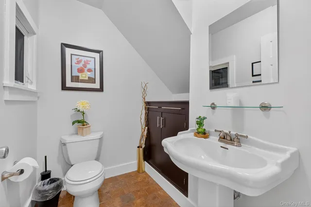 a bathroom with a sink mirror and toilet