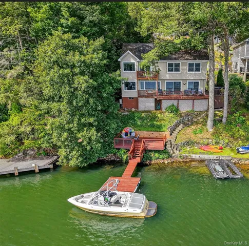 a front view of a house with a yard table and chairs